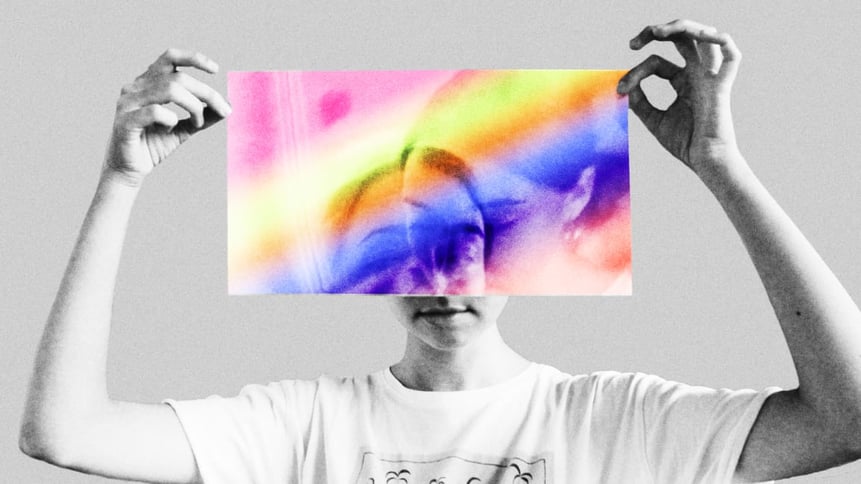 person holding rainbow paper